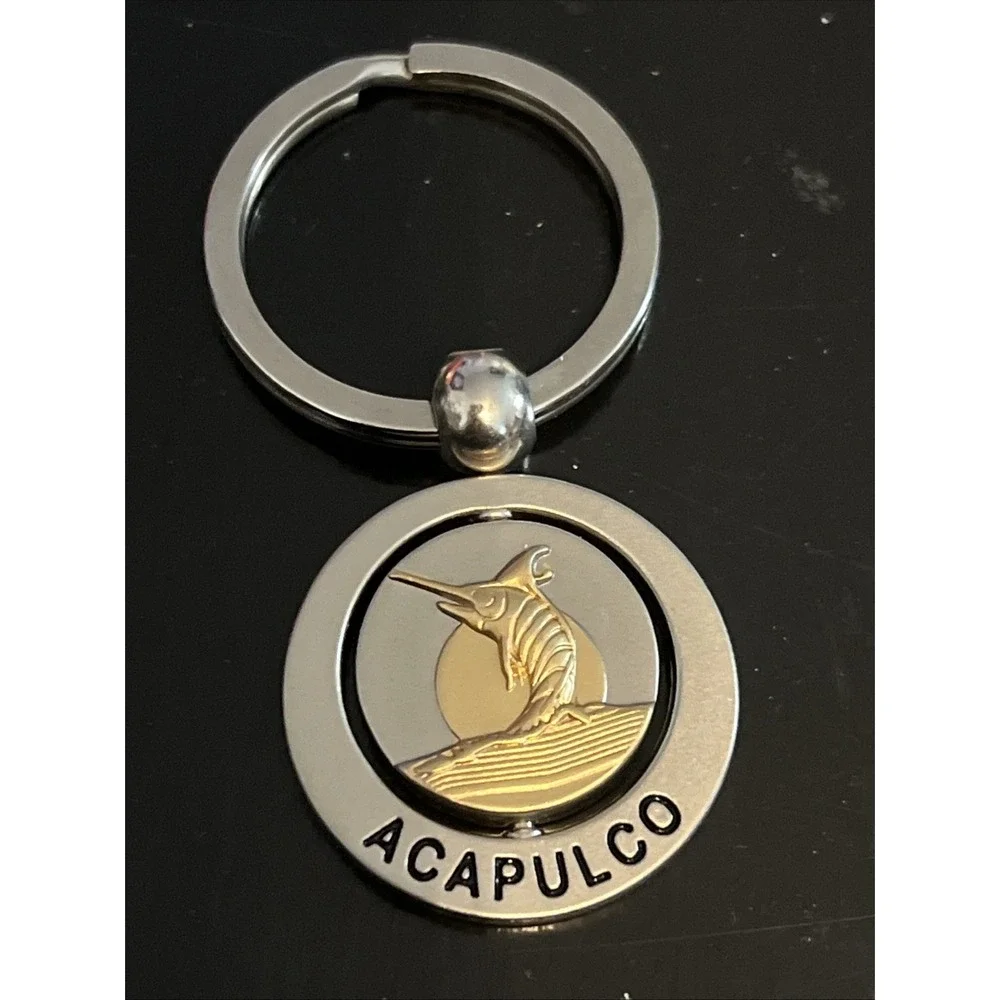 round metal Acapulco‎ souvenir keychain featuring a sailfish design